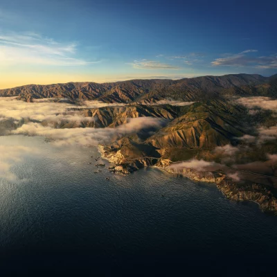 Breathtaking Aerial View of Coastal Mountains and Ocean at Golden Hour image