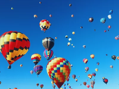 Vibrant Hot Air Balloons Soaring Across a Clear Blue Sky Festival image