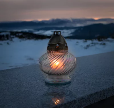 Glowing Grave Lantern on Snowy Mountain Landscape at Twilight image