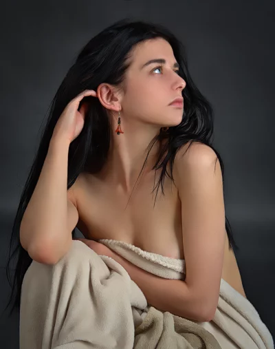 Young Woman with Flowing Black Hair and Pensive Upward Gaze image