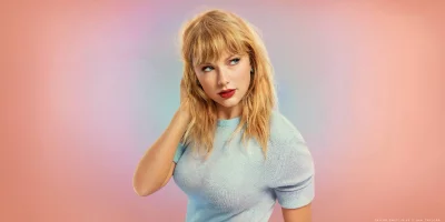 Pop Star Taylor Swift's Expressive Studio Portrait with Blonde Hair and Blue Eyes image
