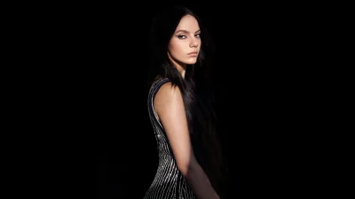 Dramatic Portrait of Elegant Young Woman in Sparkling Black Dress with Long Hair image