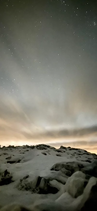 Breathtaking Starry Night Sky Over Snowy Winter Landscape with Distant Glow image