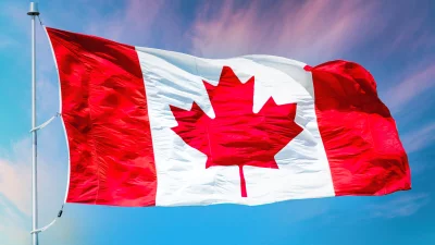 Vibrant Canadian Flag Waving Proudly Against a Dynamic Blue and Pink Sky image