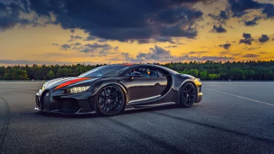 Luxurious Black Bugatti Chiron on Track at Sunset with Dramatic Sky image
