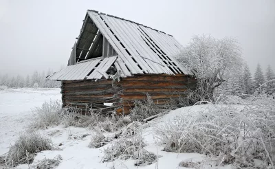 Abandoned Snowy Wooden Cabin in Winter Forest Landscape with Hoarfrost image