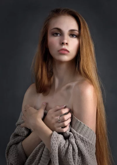 Young Woman with Long Red Hair in Knitted Sweater Studio Portrait image
