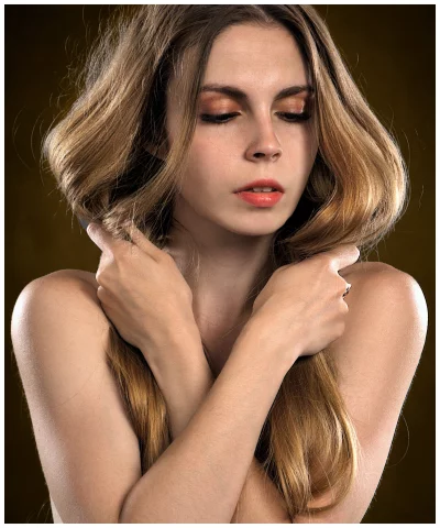 Beautiful Young Woman with Long Wavy Hair and Natural Beauty Posing Serene image
