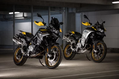 Two BMW GS Adventure Motorcycles Parked with Cinematic Lighting in Modern Urban Garage image