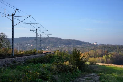 European Countryside Railway with Autumn Trees and Distant Church image