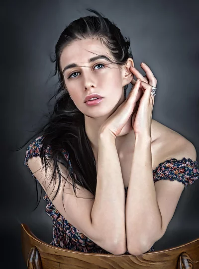 Young Woman Posing with Clasped Hands on a Carved Wooden Chair image