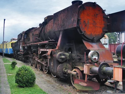 Old Heavy Duty Steam Locomotive Rusting Away on Railroad Tracks image