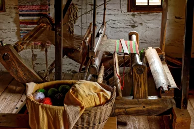 Vintage Wooden Loom with Yarn Basket in Rustic Artisan Workshop image
