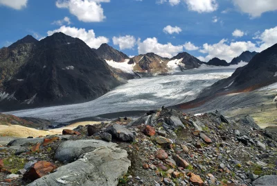 Majestic Alpine Glacier Landscape with Rocky Foreground under Blue Sky image