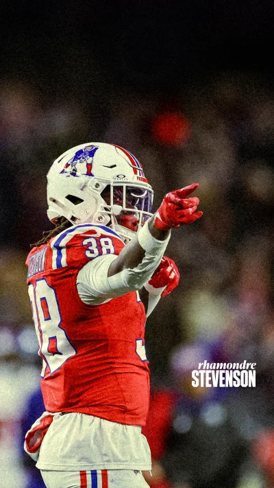 Rhamondre Stevenson Football Player Points During Game on Field image