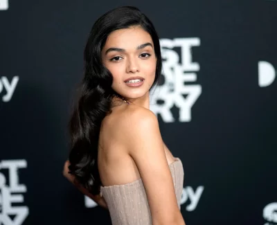 Beautiful Young Woman with Wavy Dark Hair Posing Elegantly at Premiere Event image