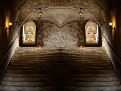Symmetrical Ancient Stone Staircase in Dimly Lit Arched Tunnel image