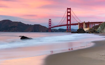 Iconic Golden Gate Bridge at Sunset with Serene Ocean Waves and Vibrant Sky image