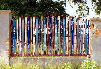 Colorful Repurposed Skis Form Unique Garden Fence with Rustic Charm image