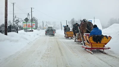 Winter Kulig: Horse-Drawn Sleighs and Car on Snowy Rural Road image