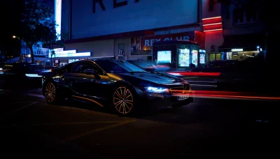 Luxury Electric Sports Car Driving Through a Vibrant City at Night with Dynamic Light Trails image