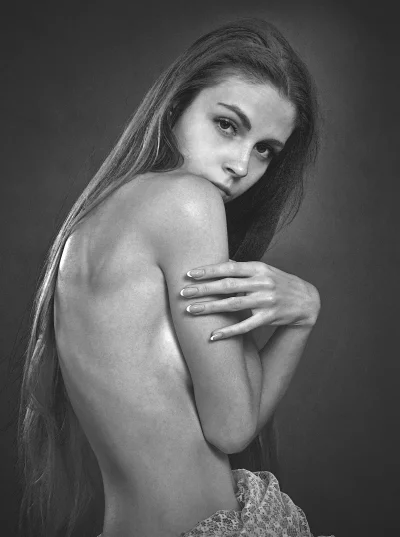 Artistic Black and White Portrait of Young Woman with Long Hair and Expressive Gaze image