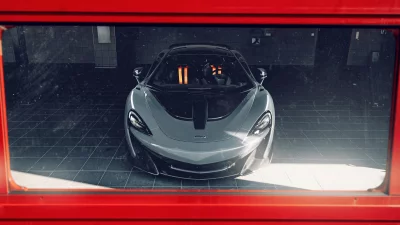 Sleek Grey McLaren Supercar Framed in Red, Luxury Sports Car Showroom View image