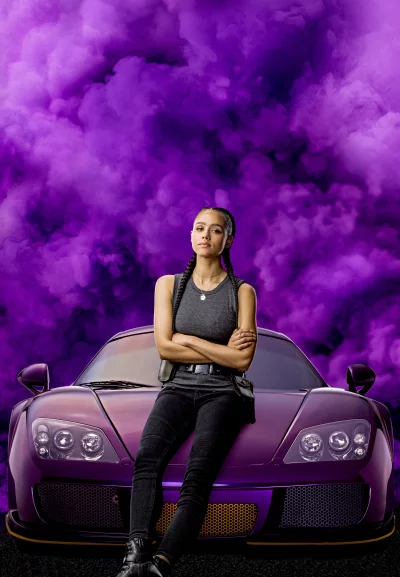 Confident Woman Posing with Luxury Purple Sports Car Amidst Vibrant Smoke image