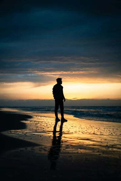 Solitary Figure Beach Sunset Reflection