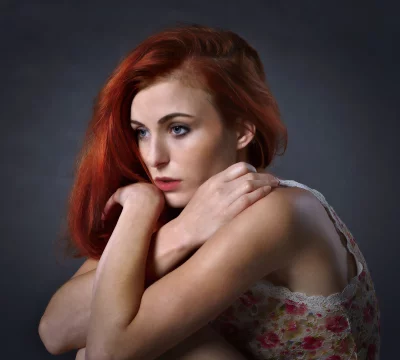 Contemplative Red-Haired Woman in Pensive Pose with Floral Lace image