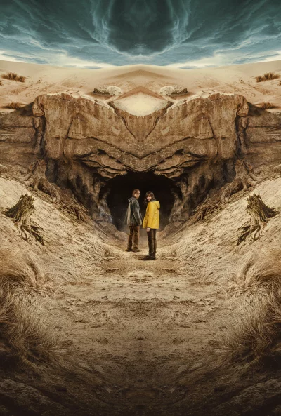 Cinematic View of Two Young People Standing at Mysterious Desert Cave Entrance HD Wallpaper image