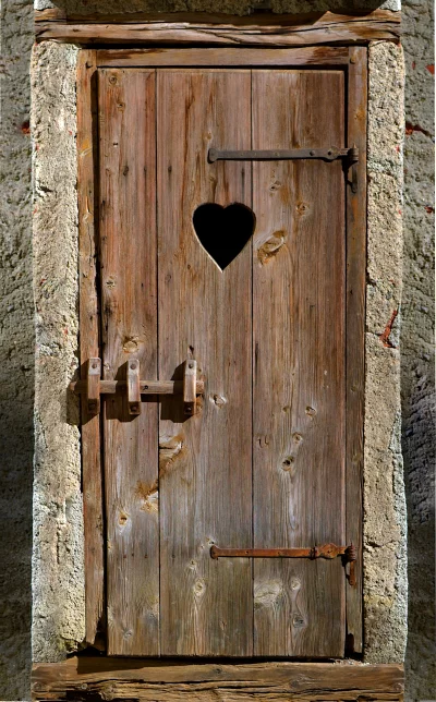 Rustic Wooden Outhouse Door with Heart Shaped Cutout image