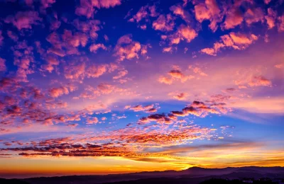 Vibrant Colorful Sunset Sky with Dramatic Clouds and Mountain Landscape Cinematic Wallpaper Style image