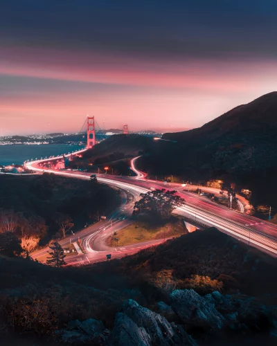 Golden Gate Bridge at Twilight with Dynamic Traffic Light Trails image