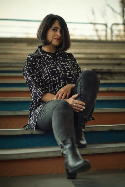 Stylish Woman Sitting on Painted Urban Stairs