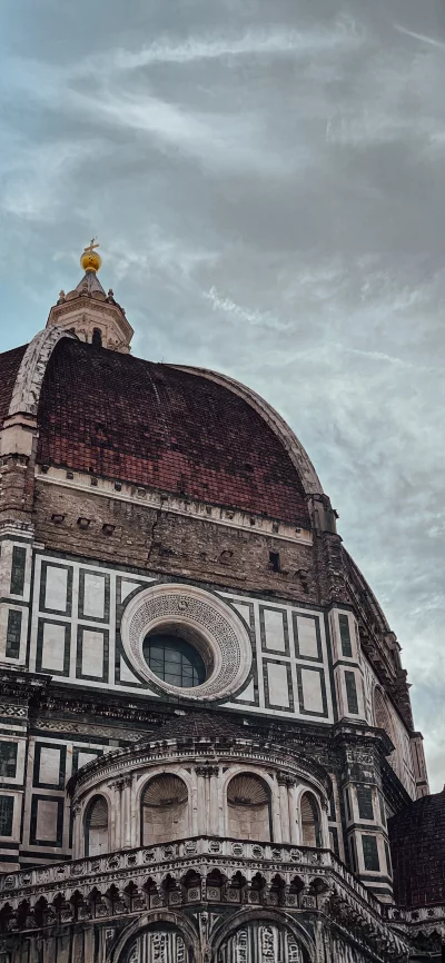 Historic Florence Cathedral Dome and Ornate Facade Against a Dramatic Cloudy Sky image