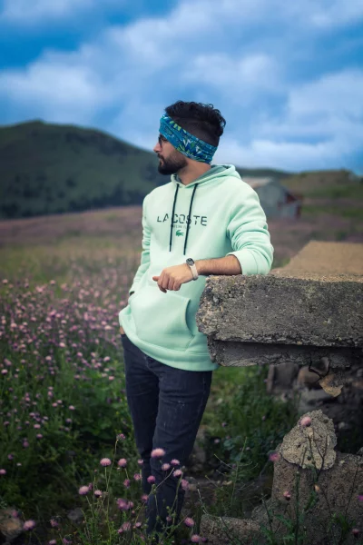 Stylish Man in Mint Green Hoodie in Wildflower Meadow