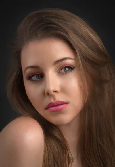 Pensive Young Woman with Long Brown Hair and Pink Lipstick image