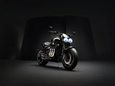 High-Performance Black Cruiser Motorcycle with Dual Glowing Headlights in Dark Studio image
