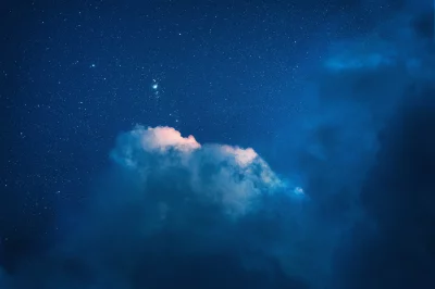 Starry Night Sky with Luminous Clouds and Distant Cosmic Nebula image
