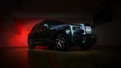 Rolls-Royce Cullinan Black Badge SUV Parked with Dramatic Red Lighting Cinematic Style Wallpaper image
