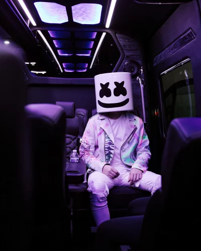 Electronic Music Artist in Iconic Helmet and Colorful Jacket in Luxury Vehicle image