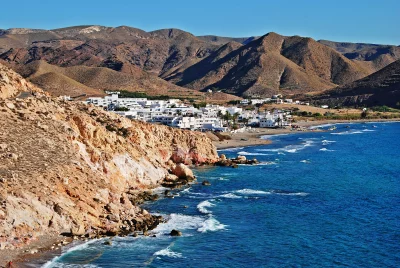 Picturesque Coastal Village Nestled by Rocky Cliffs and Vibrant Blue Mediterranean Sea image