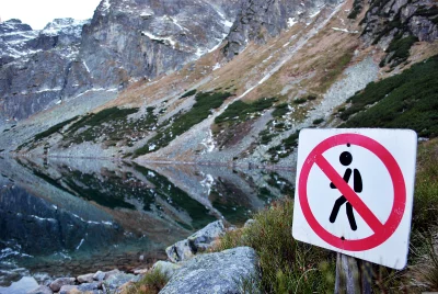 Serene Mountain Lake View with No Entry Sign in Rugged Alpine Landscape image