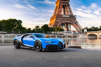 Blue Bugatti Chiron Hypercar Parked by Eiffel Tower at Golden Hour in Paris image