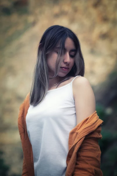 Pensive Young Woman in Nature with Draped Cardigan