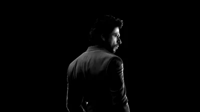 Pensive Man in Tailored Suit, Silhouette Against Dark Background with Rim Lighting image