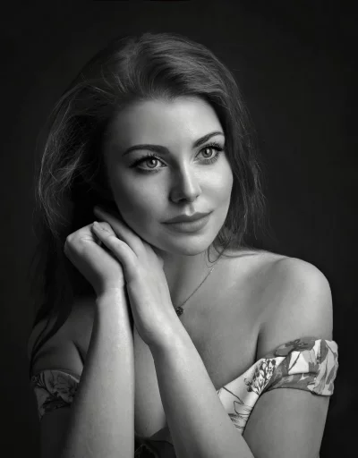 Elegant Black and White Portrait with Clasped Hands and Serene Expression image