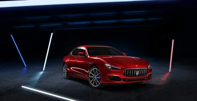 Sleek Red Maserati Ghibli Sports Sedan Under Dynamic Neon Lighting image