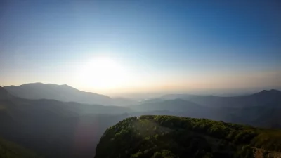 Serene mountain landscape at sunrise with a clear blue sky